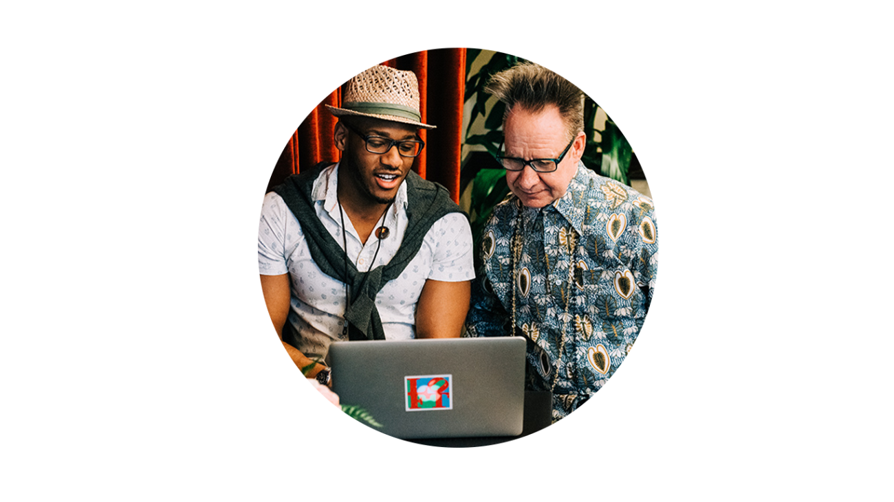 Two people looking at a laptop.