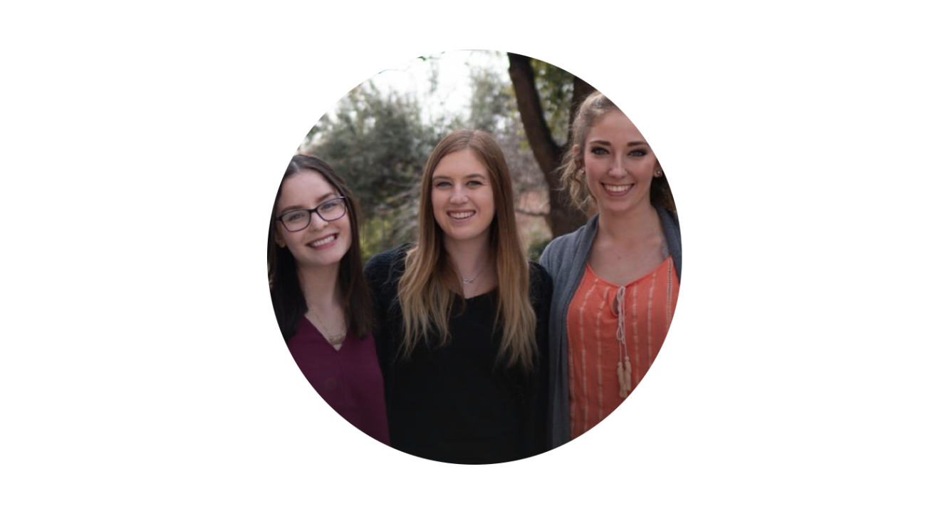 Three women posing for a picture.