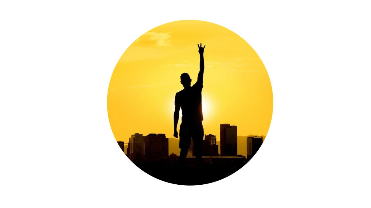 The silhouette of an ASU student giving the "pitchfork" sign against a sunset background. 
