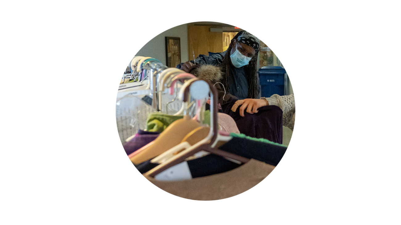 Neal Lester looking through a rack of donated clothes.