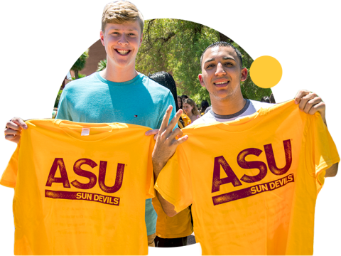 Two ASU students hold up "ASU Sun Devils" t-shirts at Welcome Week.