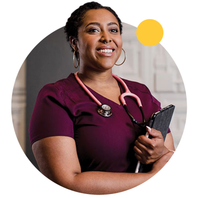 An ASU graduate wears scrubs and a stethoscope. 
