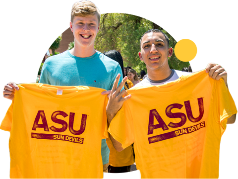 Two ASU students hold up "ASU Sun Devils" t-shirts at Welcome Week.
